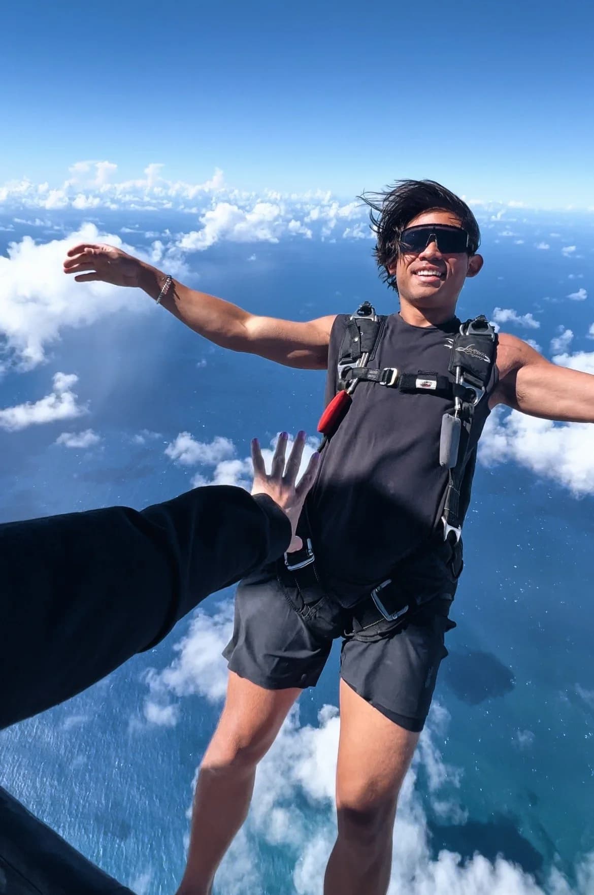 Eric Sierra skydiving over a coastal landscape