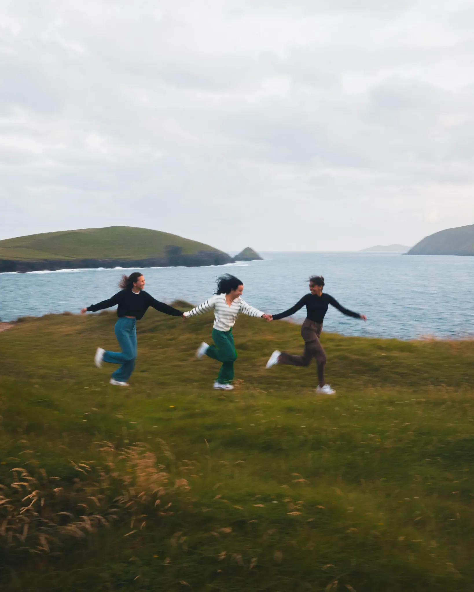 Creators running together beside the coast in Ireland